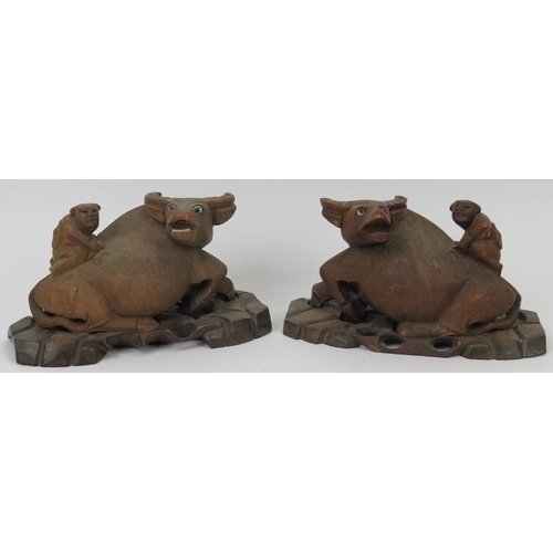 177 - A pair of Chinese carved hardwood buffalo groups, early 20th century. Both carved depicting a figure... 