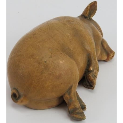 19 - A rare vintage ceramic piggy bank, possibly French. Modelled as a recumbent sleeping pig. Impressed ... 