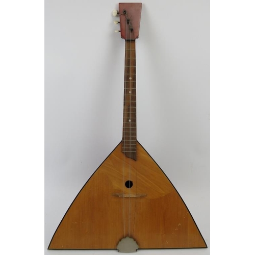 201 - A wooden three string Balalaika, 20th century. 67.5 cm length. 
Condition report: Some wear with age... 