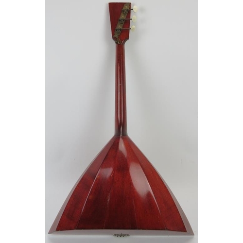 201 - A wooden three string Balalaika, 20th century. 67.5 cm length. 
Condition report: Some wear with age... 