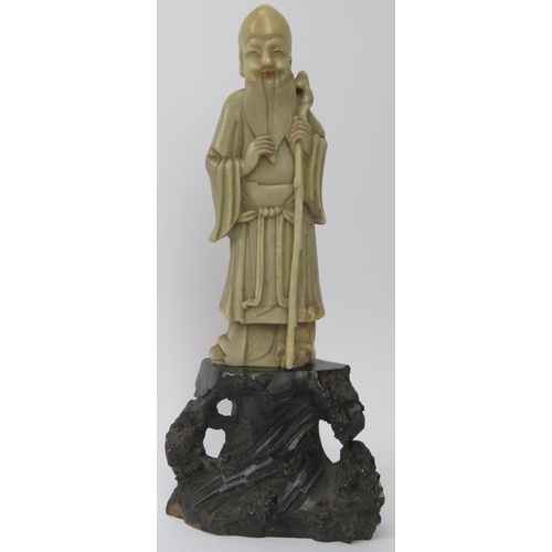 210 - A Chinese hardstone carving of a sage on a rocky outcrop, 20th century. 22.6 cm height. 
Condition r... 