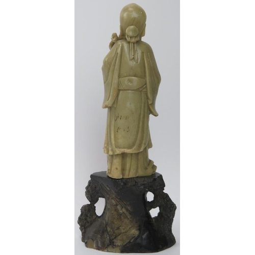 210 - A Chinese hardstone carving of a sage on a rocky outcrop, 20th century. 22.6 cm height. 
Condition r... 