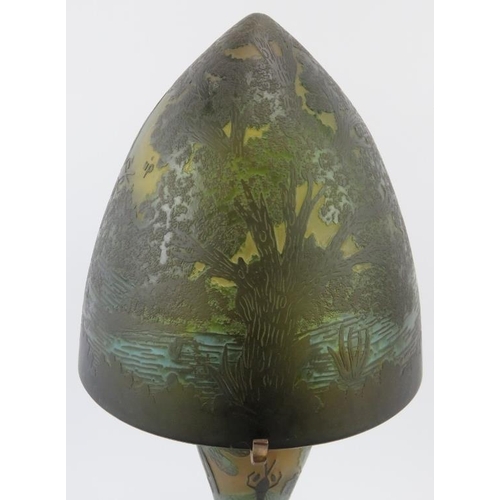 251 - A Galle style overlay glass table lamp and shade, late 20th century. Decorated depicting a rural lak... 