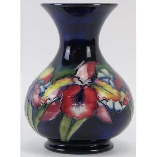 255 - A Walter Moorcroft Orchid pattern vase, circa 1940s. Tubeline decorated with Orchids against a blue ... 