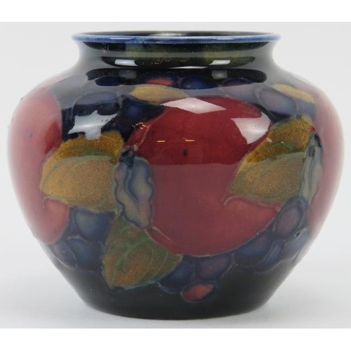 258 - A William Moorcroft Pomegranate pattern vase, circa 1913 - 1925. Tubeline decorated with leaves and ... 