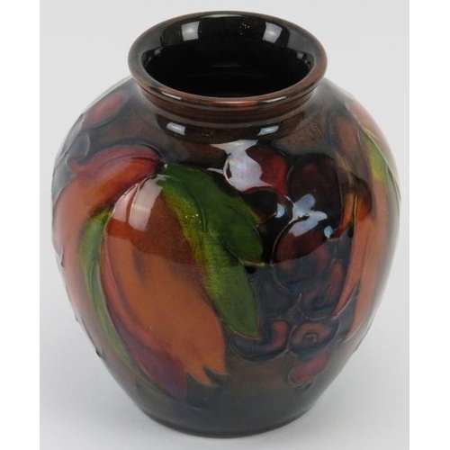 259 - A William Moorcroft flambe glazed Leaf and Berry pattern vase, circa 1928 - 1934. Tubeline decorated... 