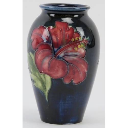 261 - A Walter Moorcroft Hibiscus pattern vase, circa 1950/60s. Tubeline decorated with Hibiscus against a... 