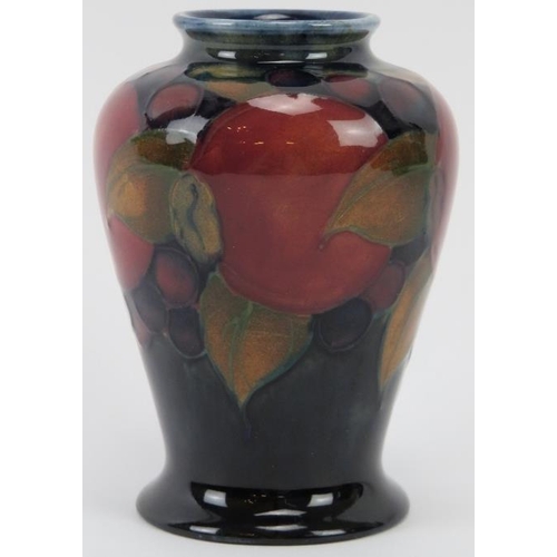 285 - A William Moorcroft Pomegranate pattern vase, circa 1920s. Impressed factory marks beneath. 8.8 cm h... 