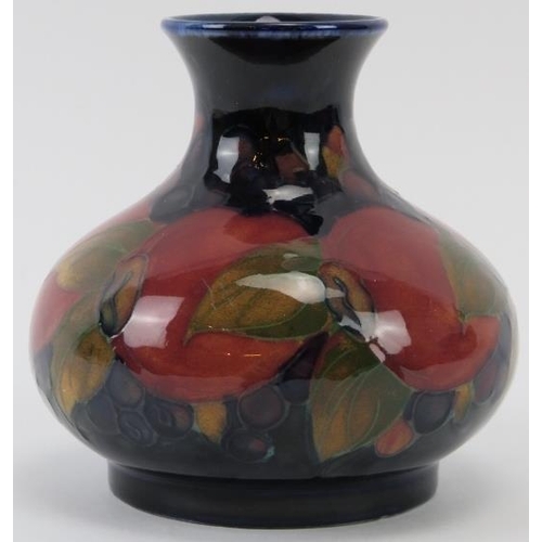 287 - A William Moorcroft Pomegranate pattern vase, circa 1920s. 9.3 cm height. Initialled W. M. in green ... 