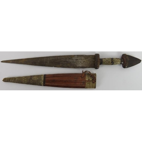 29 - Tribal Art: An African dagger, probably Hausa people, Nigeria. The pommel formed from the tip of a b... 