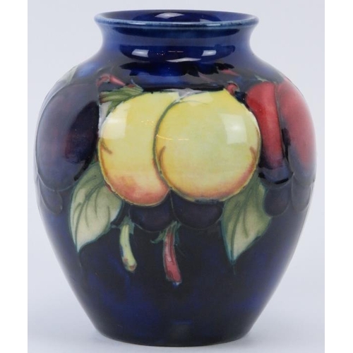 295 - A William Moorcroft Wisteria pattern vase, circa 1920s. Initialled W. M. in blue with impressed fact... 