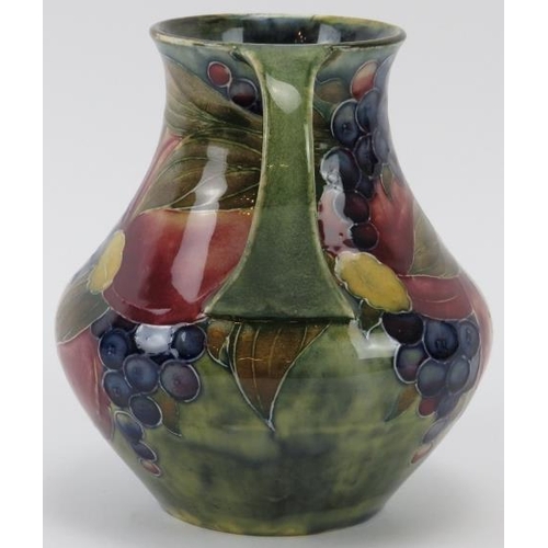 297 - A William Moorcroft Pomegranate pattern twin handled vase, circa 1914. Signed ‘W. Moorcroft 1914’ in... 