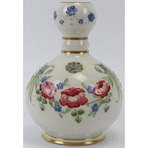 299 - A William Moorcroft Rose Garland pattern knopped vase, circa 1904. Gilt decorated with rose and forg... 