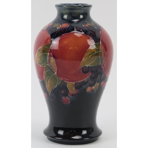 300 - A William Moorcroft Burslem Pomegranate pattern vase, circa 1920. Signed W. Moorcroft in green with ... 