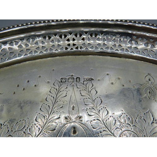 301 - A large silver engraved salver with bead edge & pierced decoration sitting on three feet, Sheffield ... 