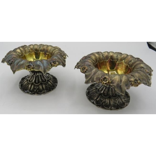 303 - A pair of Georgian silver pedestal dishes embossed with foliate design, gilded interior, London 1829... 