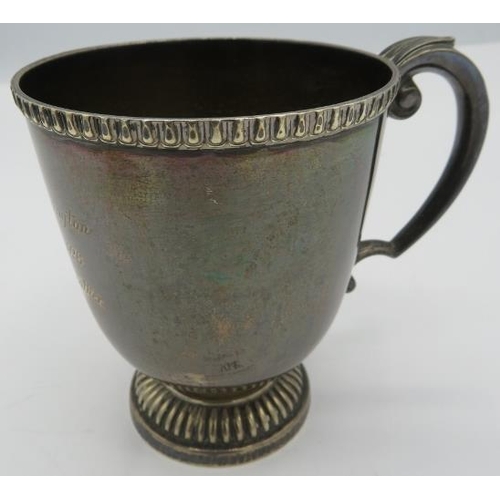 304 - A silver christening mug on pedestal foot & double scroll handle, Sheffield 1924, engraved on side. ... 