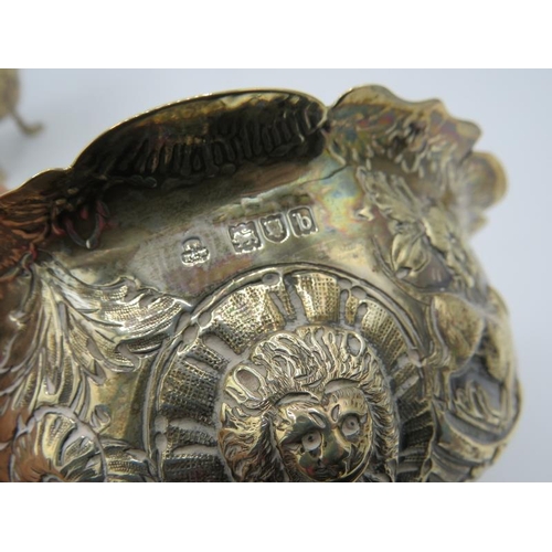 310 - A heavily embossed cream jug and sugar bowl decorated with panels of animals & lion masks, London 18... 