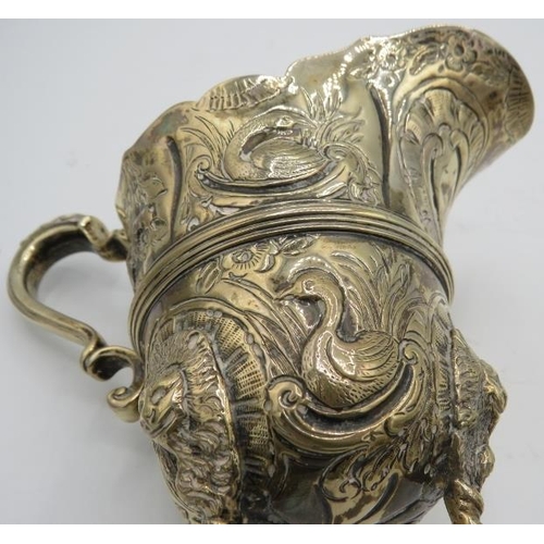 310 - A heavily embossed cream jug and sugar bowl decorated with panels of animals & lion masks, London 18... 