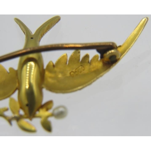 317 - A fine detailed 15ct yellow gold swallow brooch holding a seed  pearl set branch. Approx weight 4.2 ... 