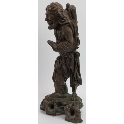 33 - A Chinese carved bamboo figure of an Immortal, early 20th century. Modelled with inset glass eyes. 4... 