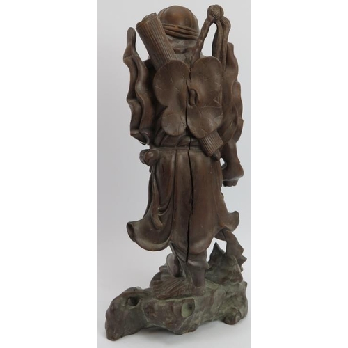 33 - A Chinese carved bamboo figure of an Immortal, early 20th century. Modelled with inset glass eyes. 4... 