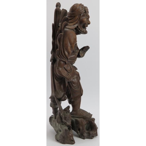 33 - A Chinese carved bamboo figure of an Immortal, early 20th century. Modelled with inset glass eyes. 4... 