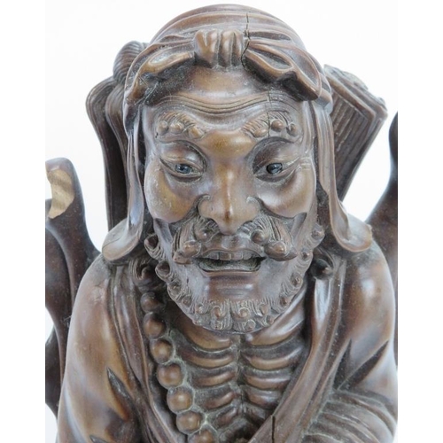 33 - A Chinese carved bamboo figure of an Immortal, early 20th century. Modelled with inset glass eyes. 4... 