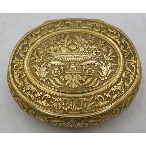 337 - A French gold engraved oval snuff box/compact with interior mirrored glass. A centre urn decorates t... 