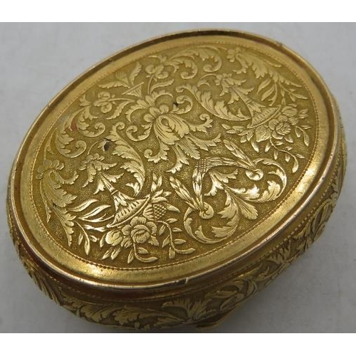 337 - A French gold engraved oval snuff box/compact with interior mirrored glass. A centre urn decorates t... 