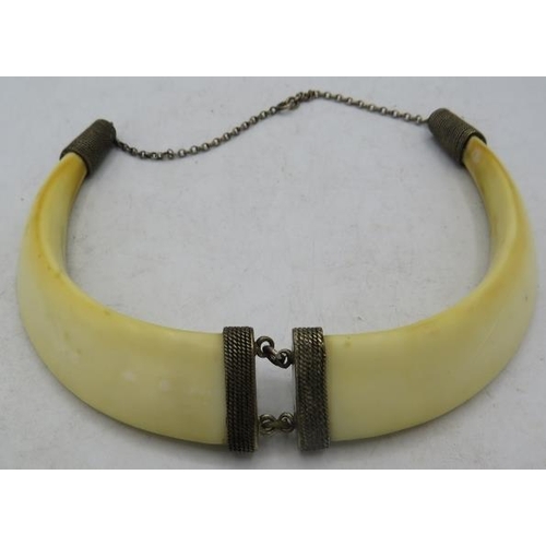 340 - A boar tusk necklace with white metal mounts. Approx 5