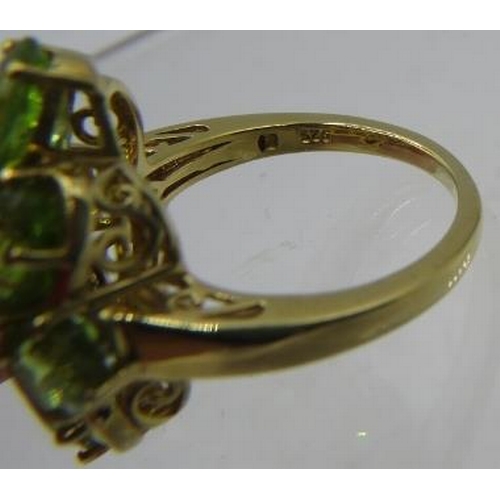 356 - Peridot ring, multi oval cut stones of good cut, colour and clarity, size Q. Overall setting 28mm x ... 