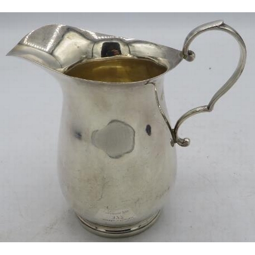 377 - A silver cream jug with footed rim and double scroll handle, Sheffield 1934, (Silver Jubilee mark). ... 