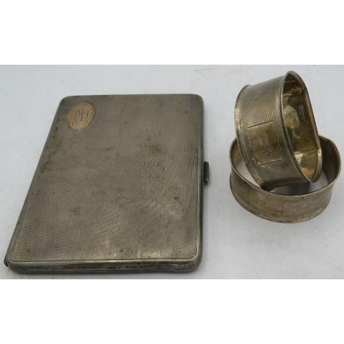 378 - A silver cigarette case with gilded interior, Birmingham 1927 and a pair of silver napkin rings, eng... 