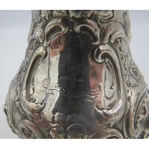 393 - A Victorian silver jug on splayed feet, double scrolled acanthus leaf handle and heavily embossed wi... 