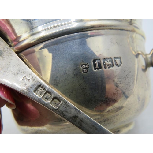 394 - A silver porringer with gilded interior and matching silver spoon. Engraved on the side, London 1906... 