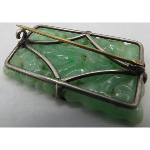 413 - A white metal rectangular carved jade brooch. Approx 2