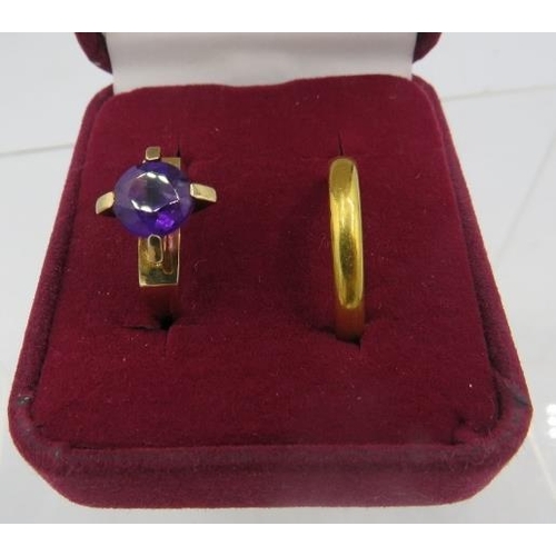 414 - A 9ct gold ring set with centre circular amethyst, approx 8mm across, size M and a 22ct gold wedding... 