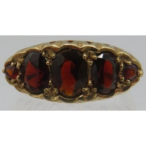 415 - A 9ct yellow gold five stone graduated faceted garnet ring. Centre garnet approx 8mm x 4mm, size L.
... 