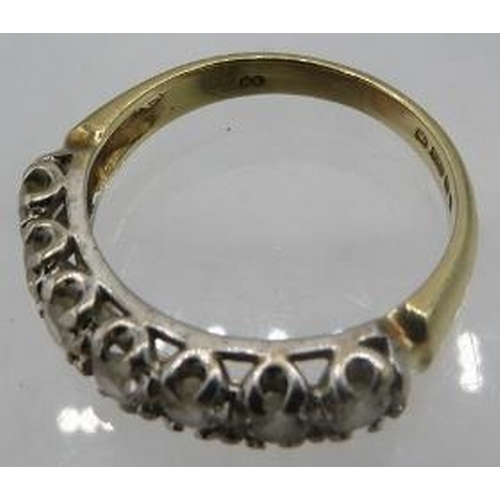 416 - A 9ct yellow gold ring set with seven white stones, size M, boxed.