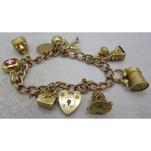 417 - A 9ct gold link charm bracelet with 9ct gold padlock clasp and ten charms. (Four 9ct gold charms, tw... 