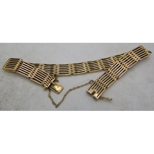 423 - A 15ct yellow gold six bar bracelet on a safety chain. Approx weight 26.8 grams.
Condition report: S... 