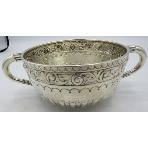 431 - A Victorian silver porringer with foliate embossed decoration and half fluting, London 1888. Approx ... 