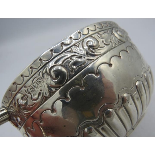 431 - A Victorian silver porringer with foliate embossed decoration and half fluting, London 1888. Approx ... 