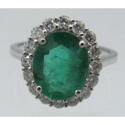 439 - A certificated 18ct white gold emerald & diamond cluster ring, size M. Oval cut emerald approx 2.3ct... 