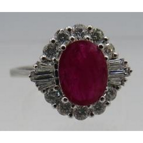 456 - An 18ct white gold oval ruby, RBC & baguette diamond cluster ring, size M. Ruby approx 1.26cts, diam... 