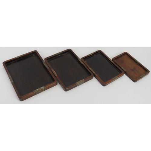 46 - A set of four Chinese graduated rosewood trays, early 20th century. Mounted with engraved brass butt... 