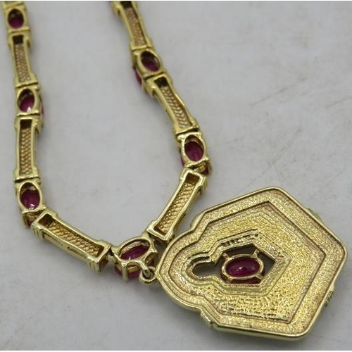 461 - A silver gilt ruby & white enamel necklace with a matching pendant, marked 925. Rubies approx 12cts ... 