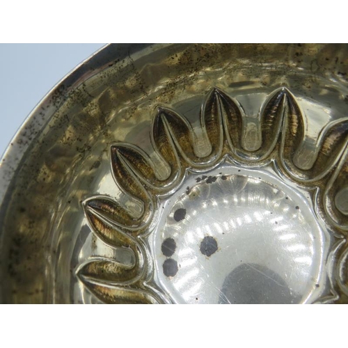 472 - A heavy silver porringer with leaf type embossed decoration, Birmingham 1929, engraved 'From Godmoth... 