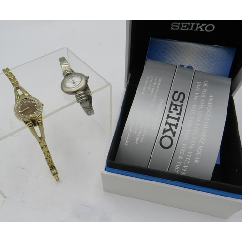 482 - A Seiko Solar V114-OAFO round gemmed case ladies wristwatch, boxed, a Hugo Buchser quartz stainless ... 